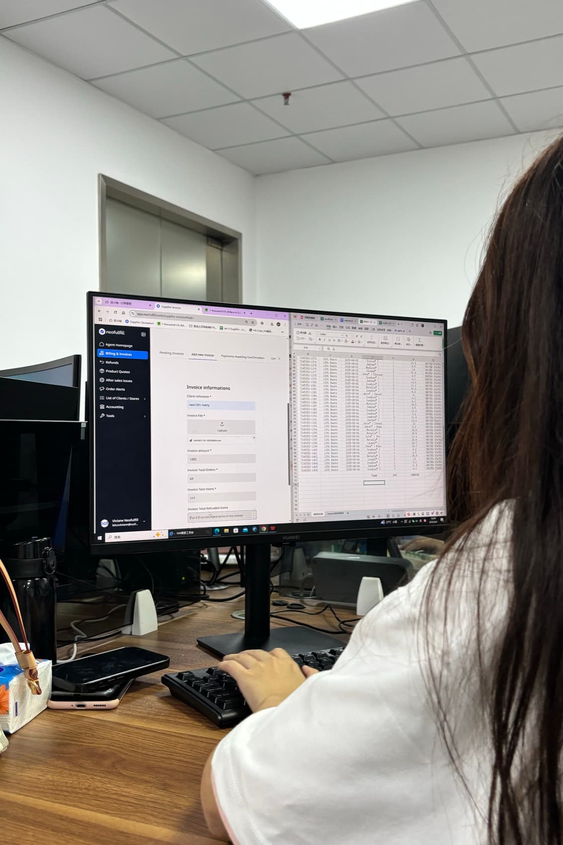 A Neofulfill team member reviewing order records on screen in the Shenzhen office.
