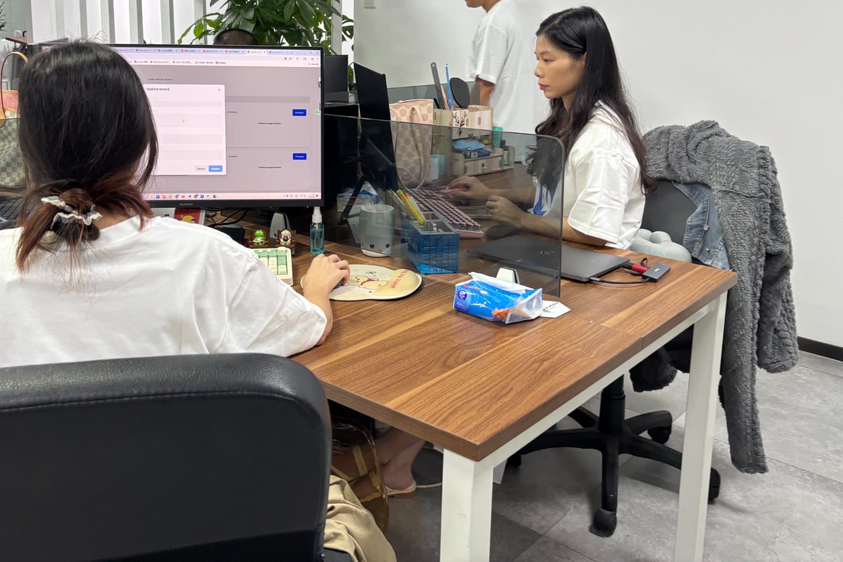 Neofulfill team members working at their screens in the Shenzhen office.