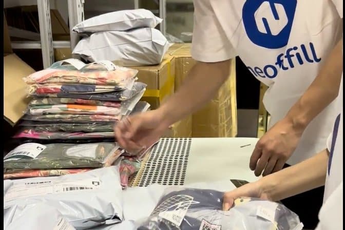 A Neofulfill team member checking polybagged garments against the order before they are packed.